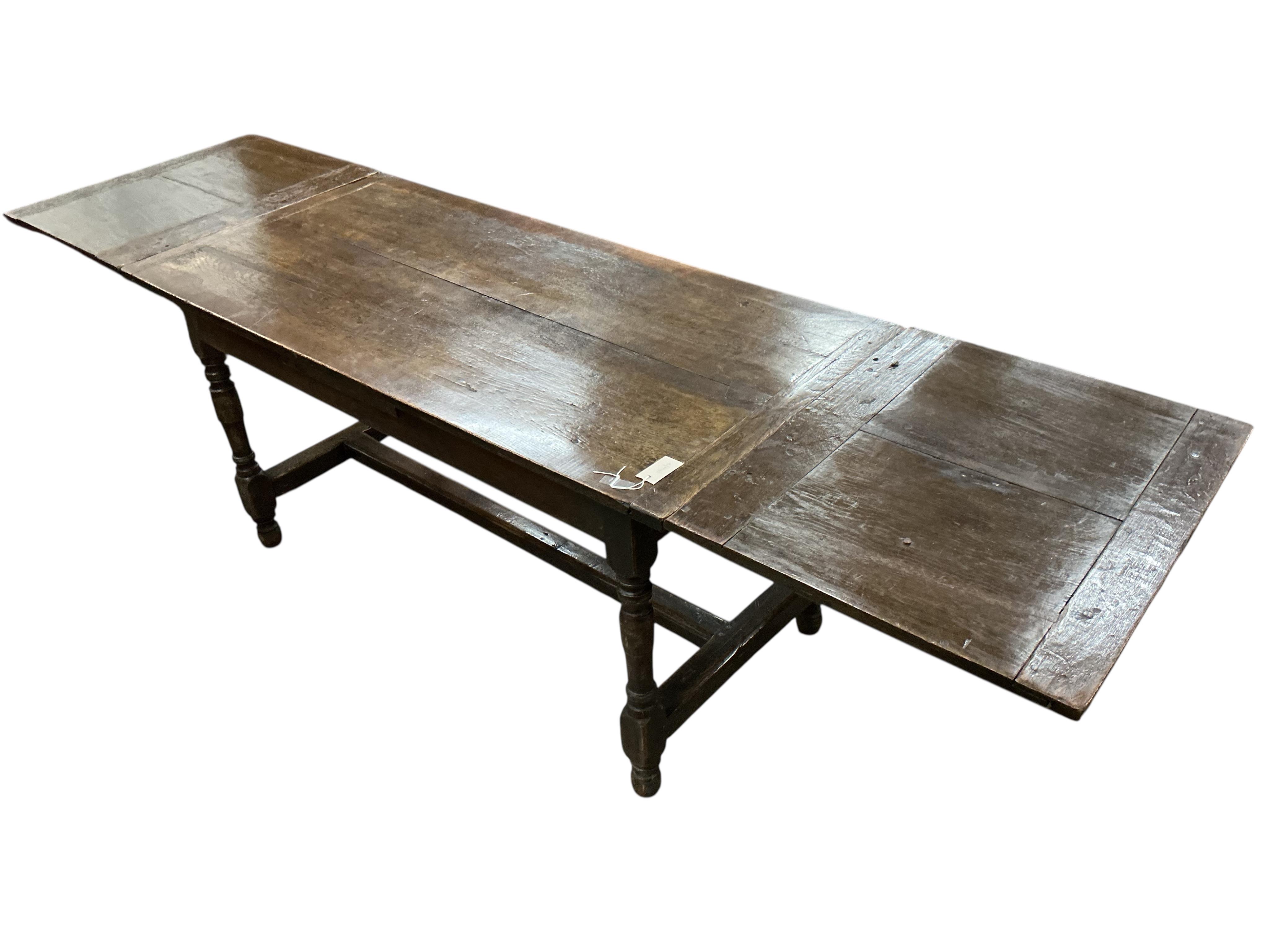 A small 18th century and later rectangular oak draw leaf refectory dining table, width 258cm extended, depth 70cm, height 75cm